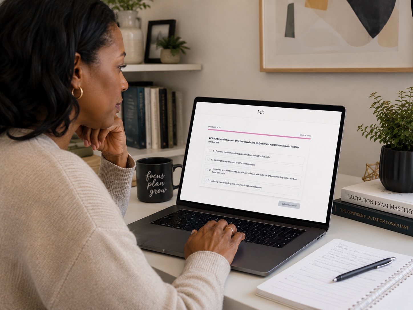 Student practicing IBCLC exam questions on laptop